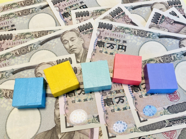 1万円札の上に並べられた5色のブロック