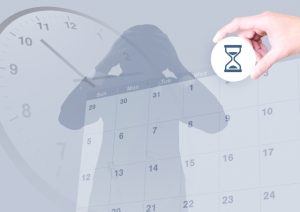 頭を抱える人のシルエットと砂時計のアイコン