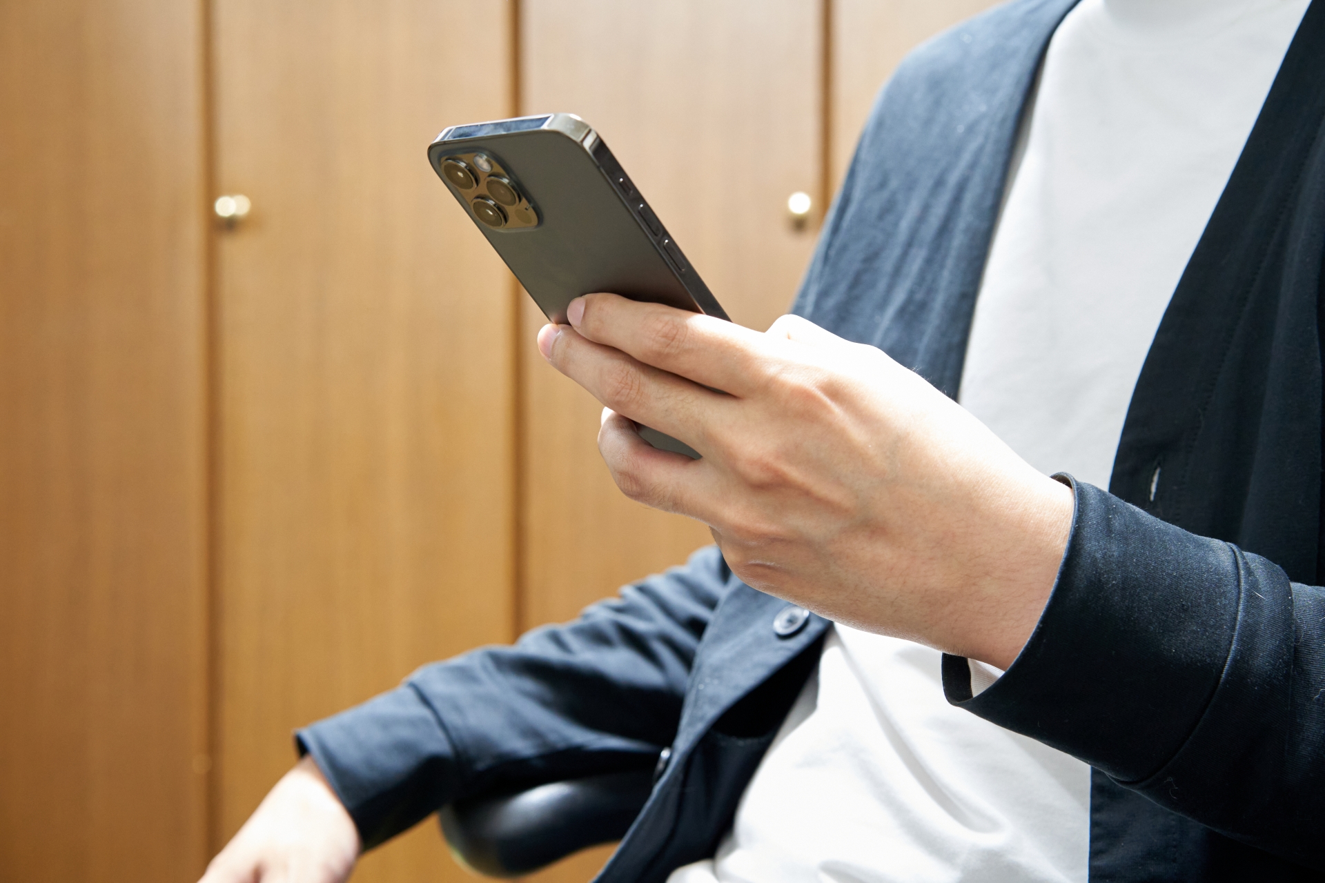 左手でスマホを操作している男性