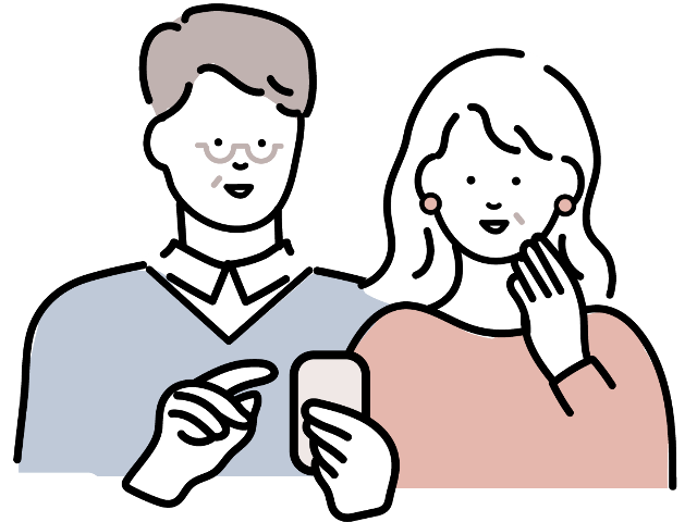 スマホ画面を見ている夫婦